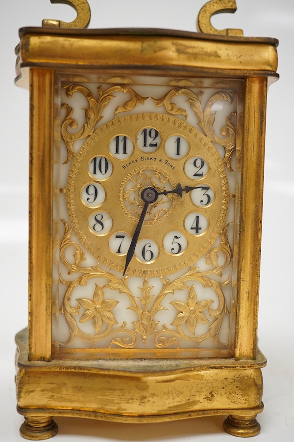 A late 19th / early 20th century ornate French gilt metal cased carriage timepiece, the dial inscribed Henry Birks, with key, 15cm high. Condition - fair, untested